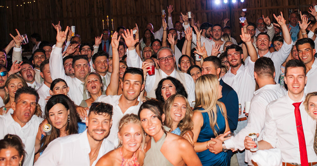 Packed dance floor at a wedding at Freedom Farms with guests dancing and celebrating.