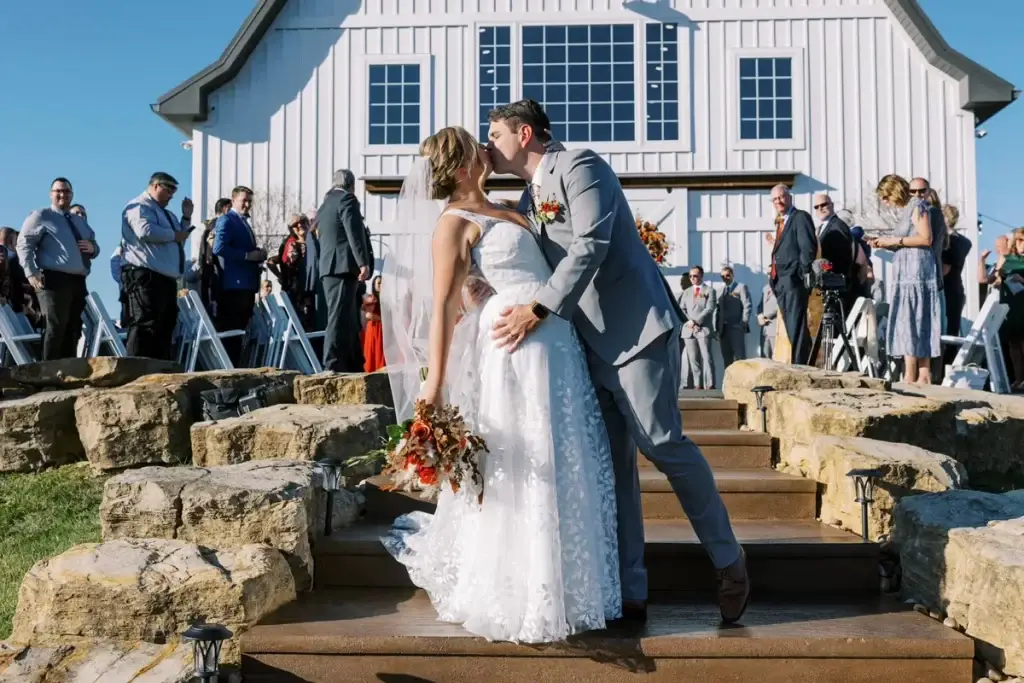 Bride and groom kissing while exiting their wedding ceremony at The Grayson House in Pittsburgh, Pennsylvania