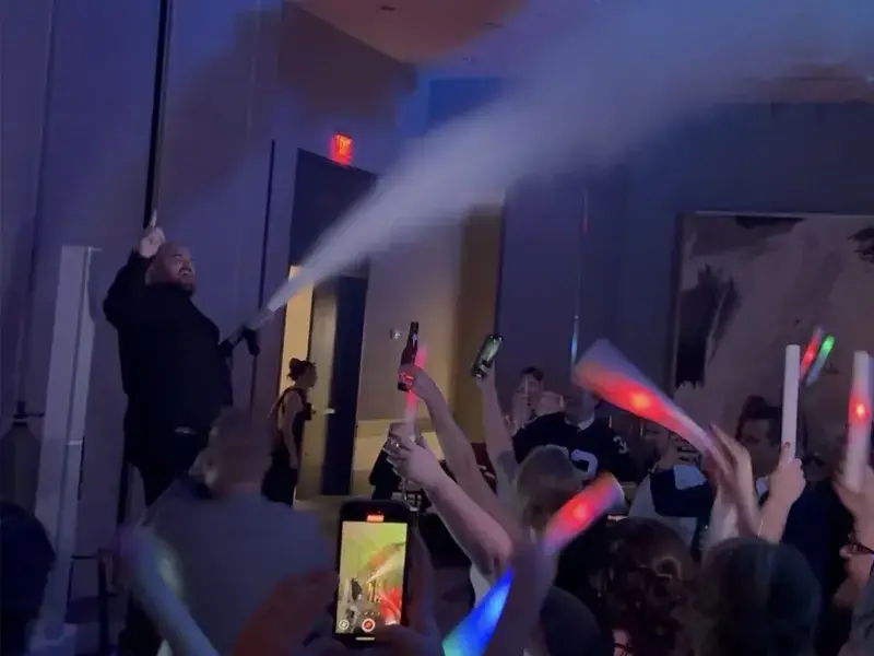 Groom using a CO2 blast effect on a packed dance floor during a wedding reception at the Fairmont Pittsburgh with Soundwaves Event Group DJ services