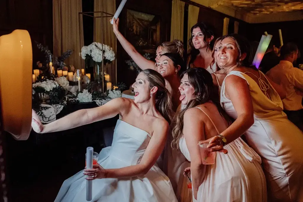 Bride and bridesmaids enjoying the Soundwaves Event Group digital photo booth on the dance floor at a Pittsburgh wedding