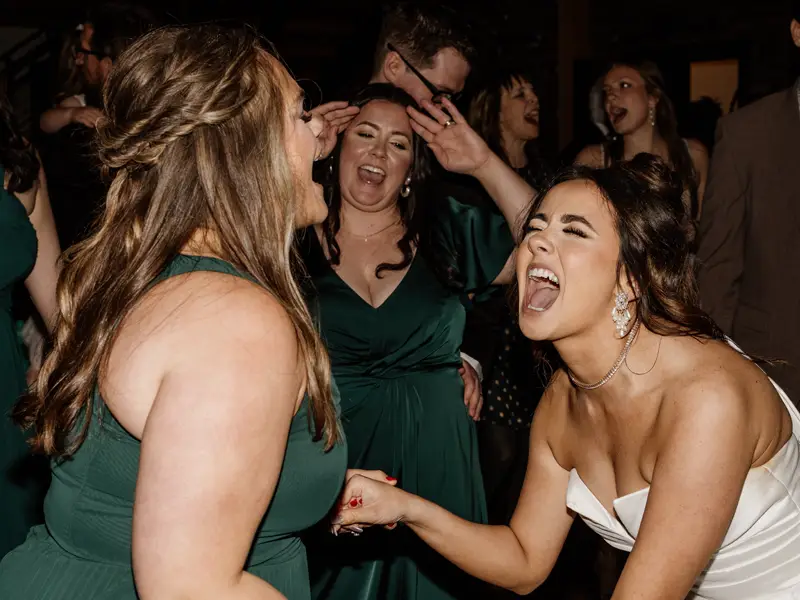 Bride singing and dancing with her bridesmaids on the dance floor at a Pittsburgh wedding reception with Soundwaves Event Group DJ services