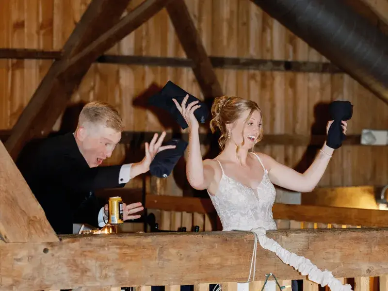Bride and groom throwing t-shirts to a packed dance floor during their wedding reception at the White Barn in Prospect, Pennsylvania with Soundwaves Event Group DJ services