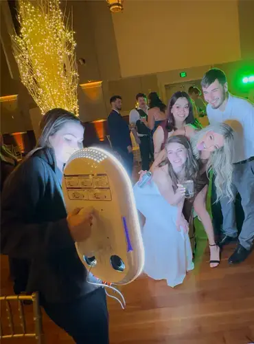 Roaming photo booth attendant capturing the bride and her friends on the dance floor at a Pittsburgh wedding