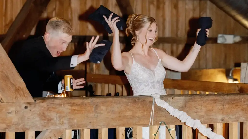 Bride and groom tossing custom t-shirts to guests during a high-energy wedding reception in Pittsburgh