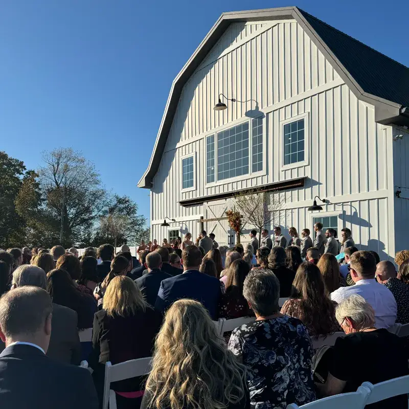 Wedding ceremony with guests gathered in front of the barn at The Grayson House in Uniontown PA