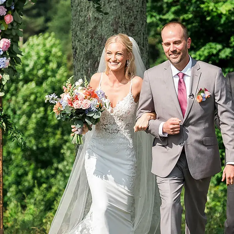 Bride and groom smiling as they exit their wedding ceremony at The Grayson House in Uniontown PA