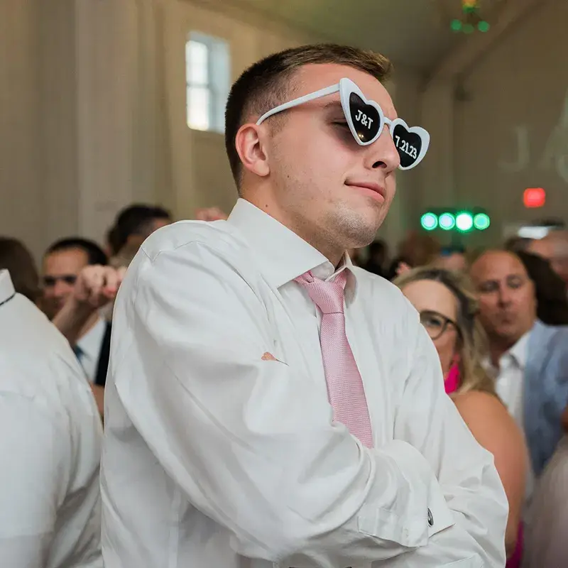 Guest wearing custom sunglasses posing on the dance floor at a wedding reception at The Grayson House in Uniontown PA