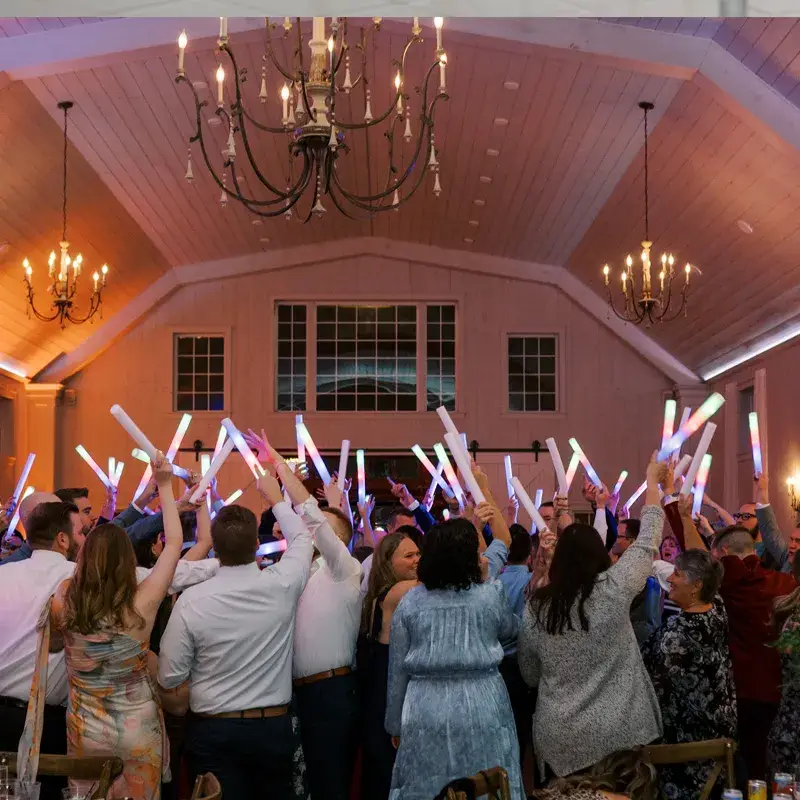 Wedding guests with hands in the air and foam sticks on a packed dance floor at The Grayson House in Uniontown PA
