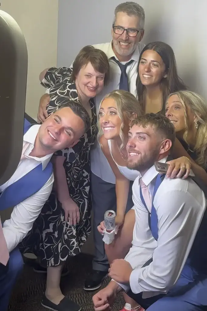 Bride and groom with a group of guests using the digital photo booth at a Pittsburgh wedding