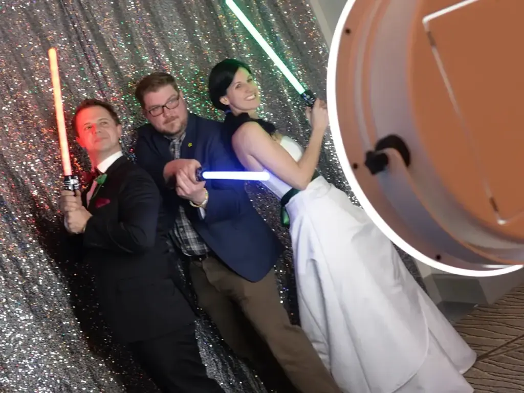 Couple posing with light sabers at Pittsburgh wedding printing Photo Booth