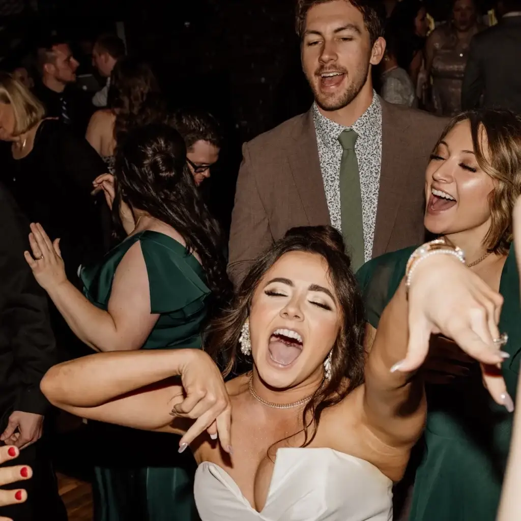 Bride and guest pointing and dancing on the dance floor at The Roost Event Center in Mahaffey PA