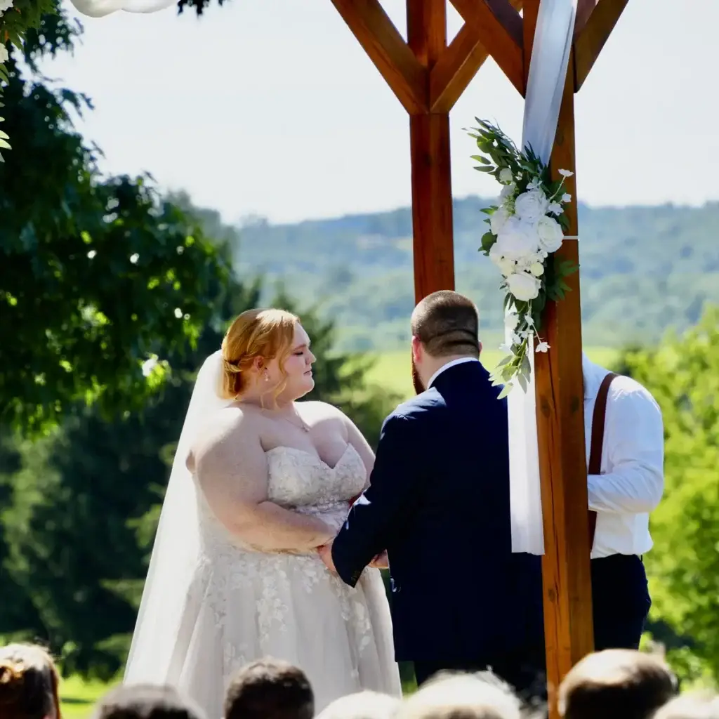 Bride and groom getting married during an outdoor ceremony at Yinzer Valley Farms in Mount Pleasant, Pennsylvania