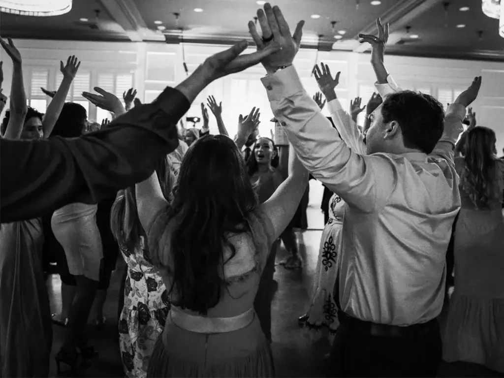 Packed dance floor with guests dancing and hands in the air at The Audrey wedding reception in Canonsburg PA