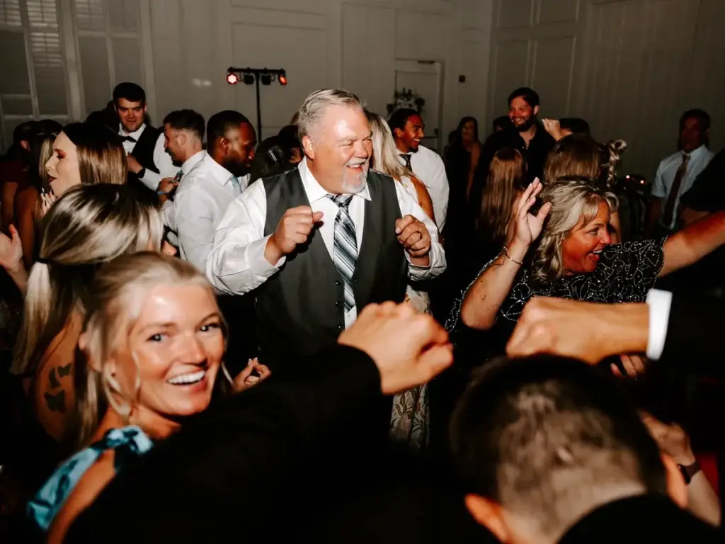 Parents smiling and dancing on a packed dance floor at The Audrey wedding reception in Canonsburg PA