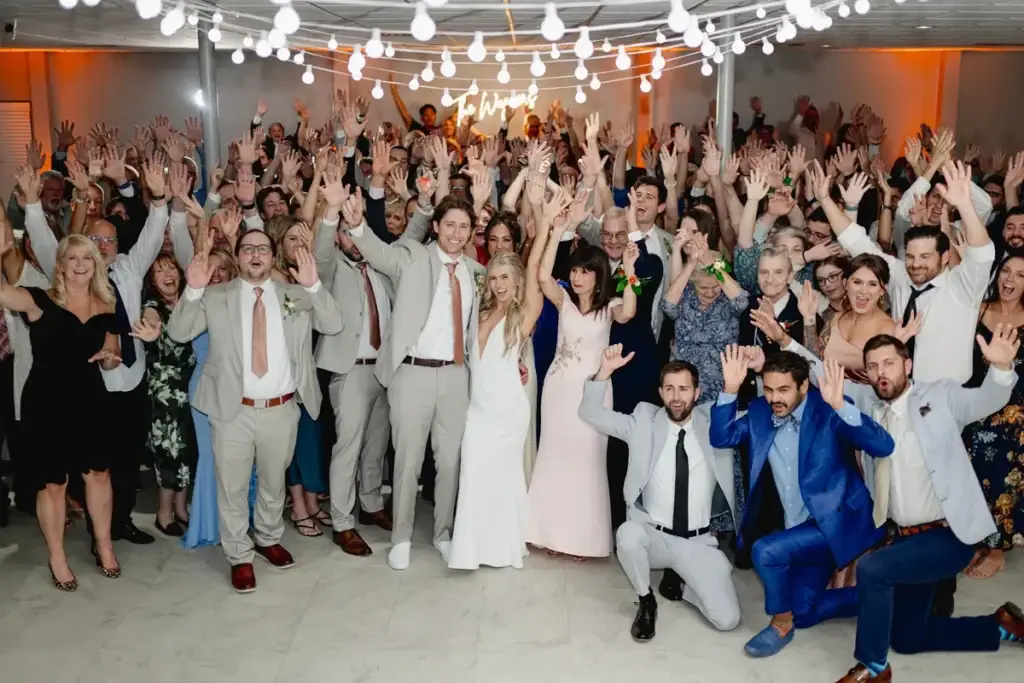 Group photo on a packed dance floor at a wedding reception at The Atrium in Butler, PA with guests celebrating and high-energy DJ entertainment by Soundwaves Event Group