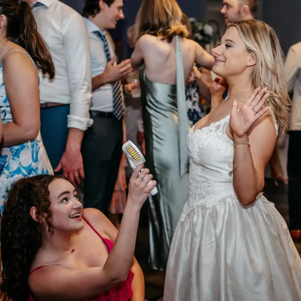 Bride being fanned by guests on a packed dance floor at Sunset Room at The Vista wedding in Elizabeth PA